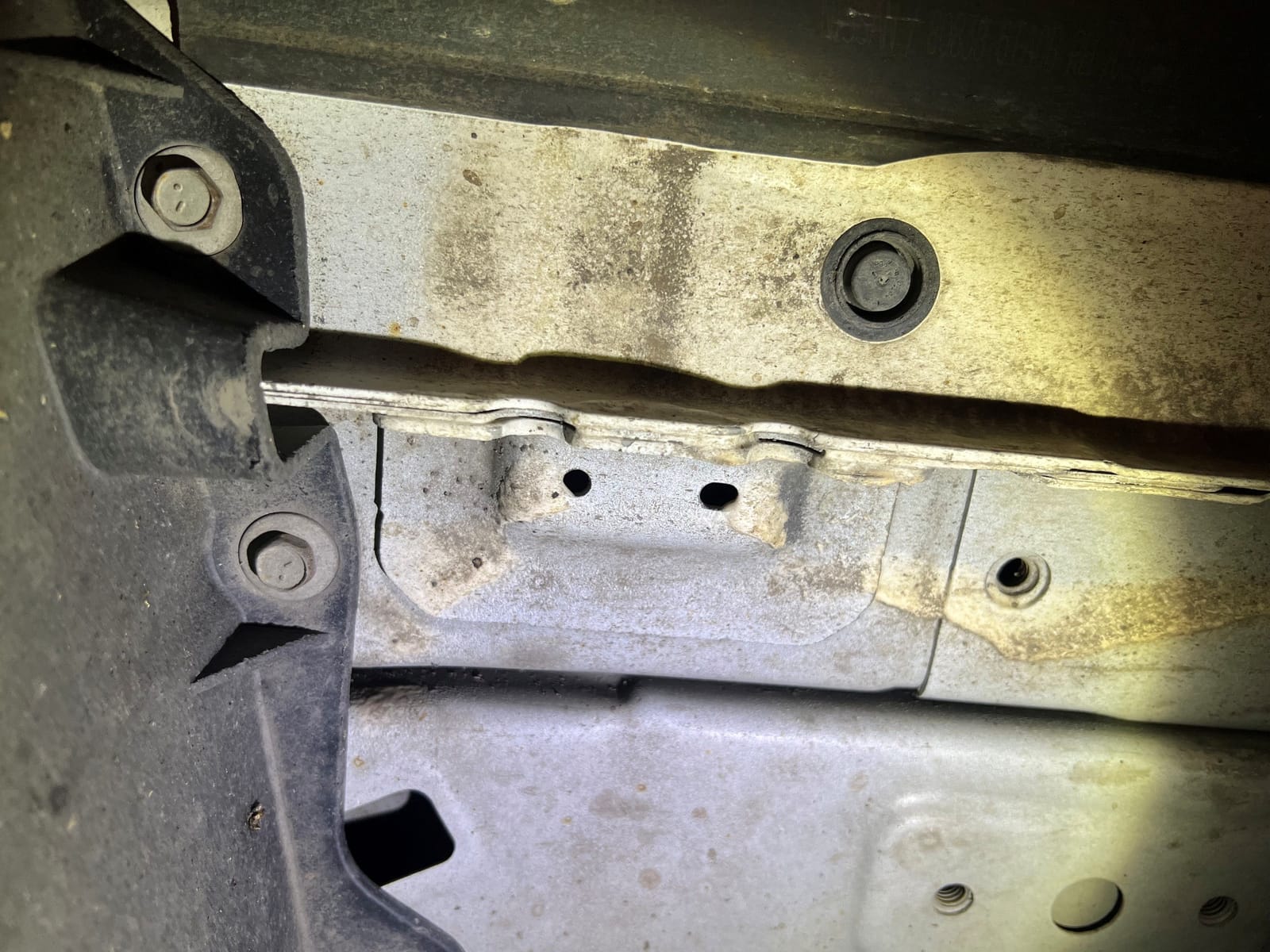 Behind the pinch weld at the jacking point, the manufacturer welds in a reinforced pad — that's the real structural point.